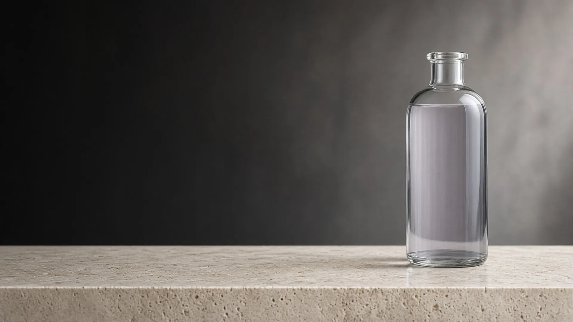 A clear unlabeled glass bottle of pale lilac liquid standing on a pale travertine ledge