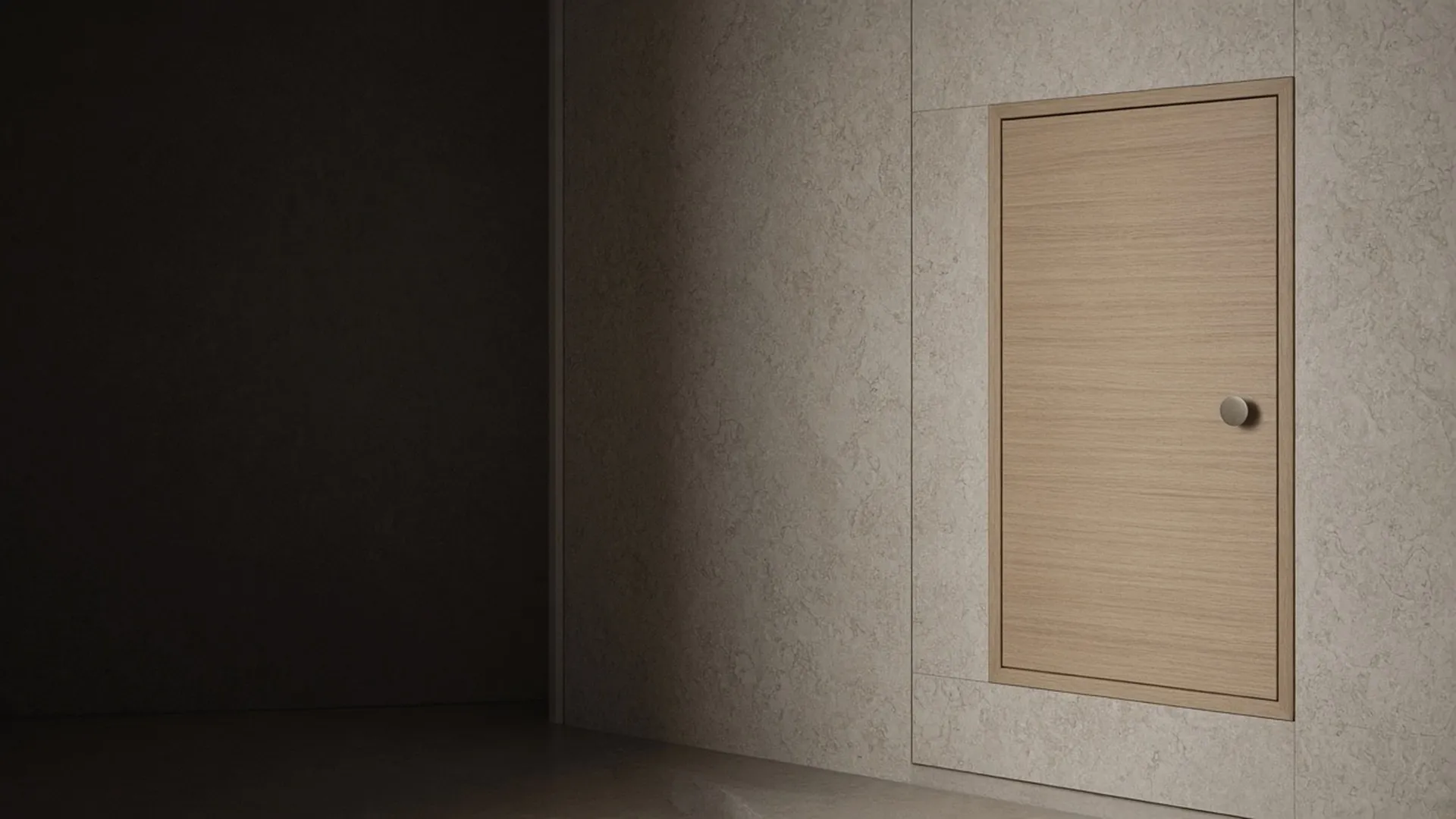 A closed pale oak cabinet door with a plain round knob in soft light